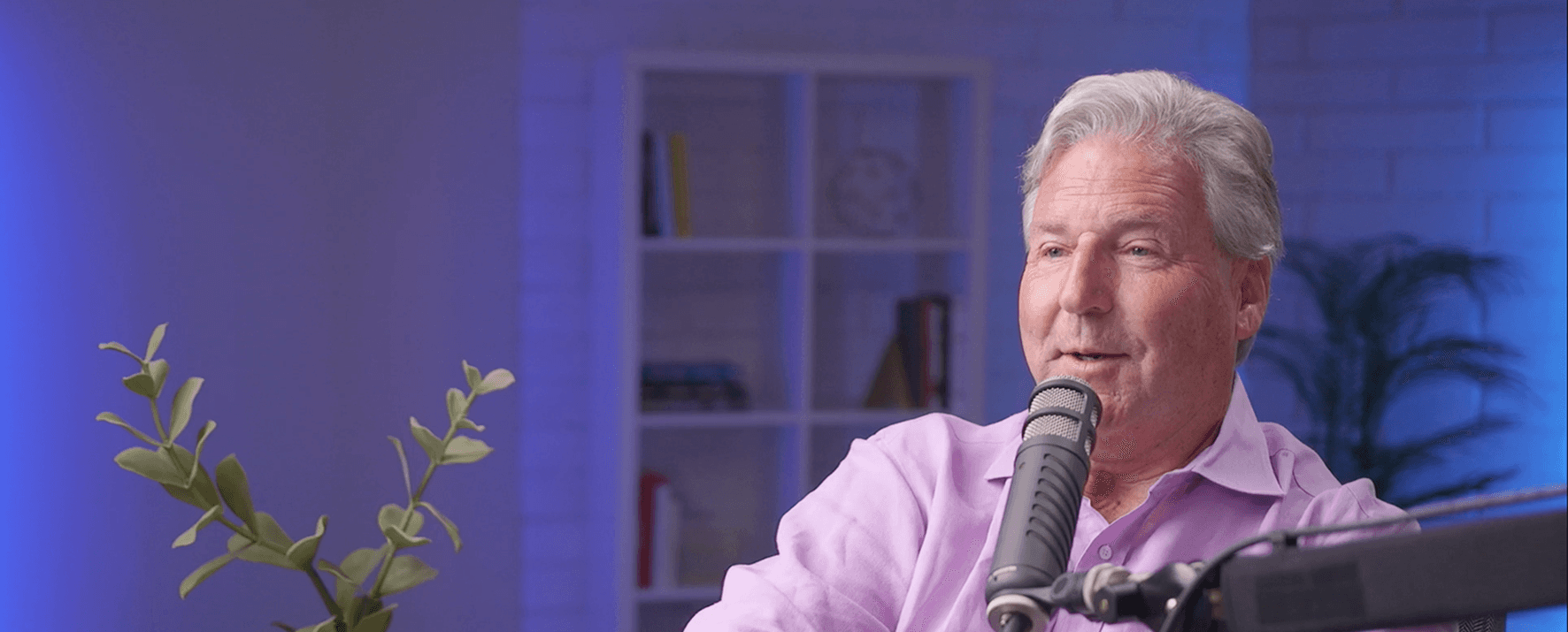 Joe Dooley speaking, seated in a warm living-room setting